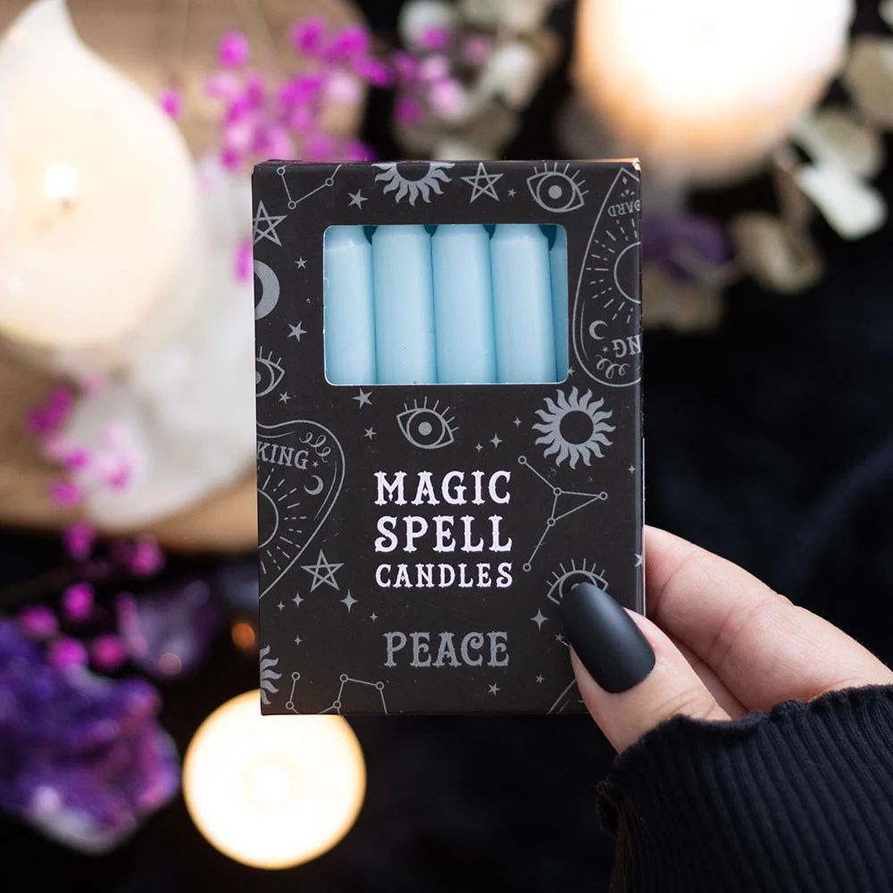 Set of 12 light blue peace spell candles arranged in a row with white wicks, vegan and unscented, 90 min burn time