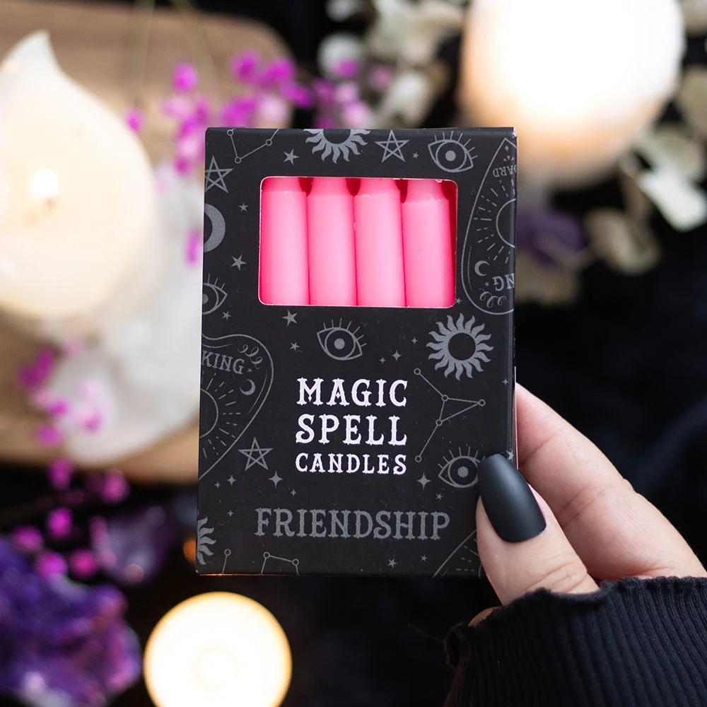 Set of 12 pink friendship candles, each upright in a tray, showing their soft pink hue and clean paraffin finish.