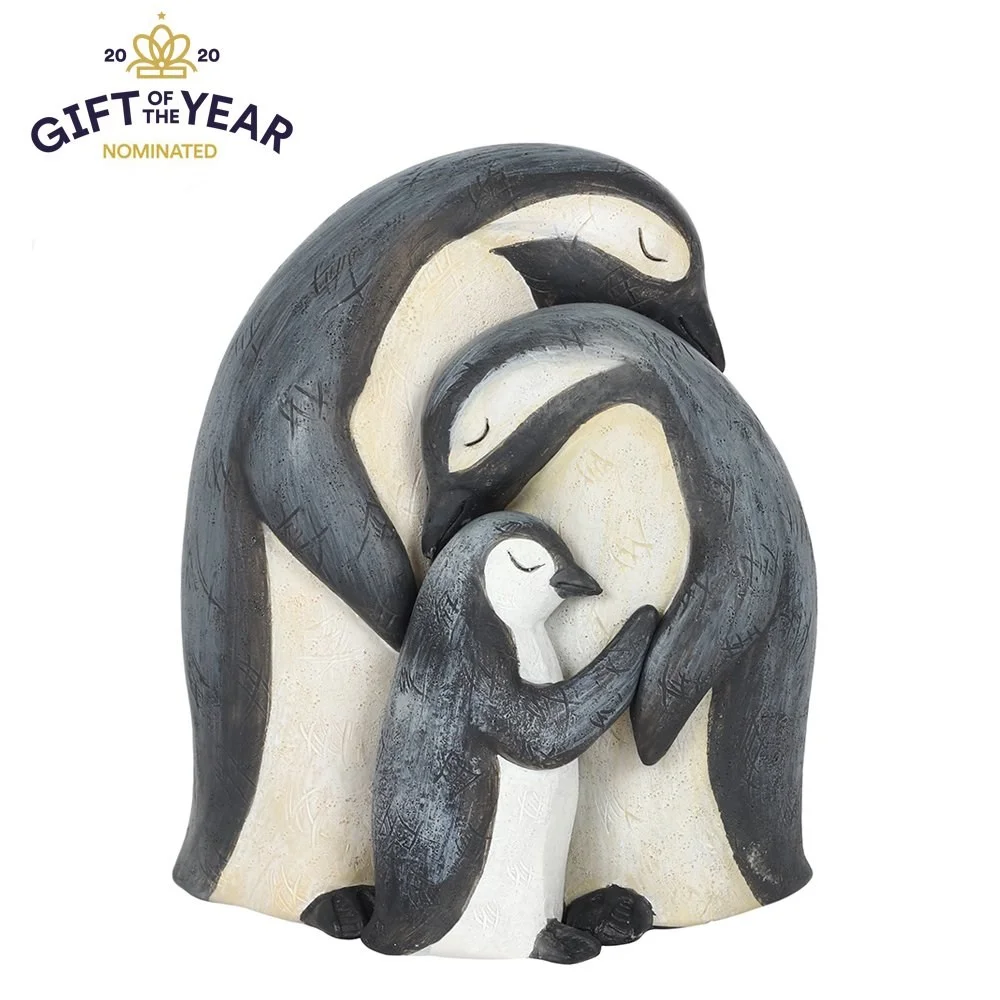 Penguin family ornament showing three penguins huddled together, packaged with a heartfelt sentiment card