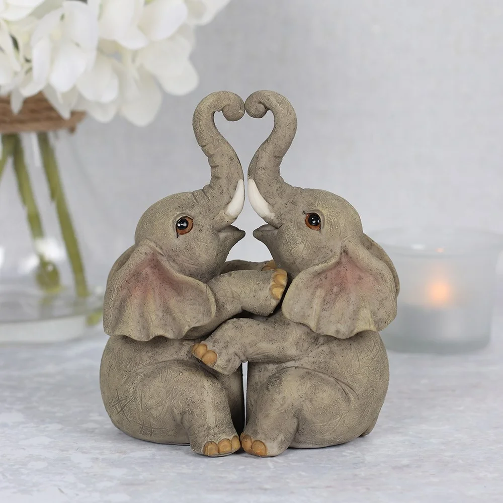 Elephant couple ornament showing two resin elephants embracing, with a sentiment card about everlasting love