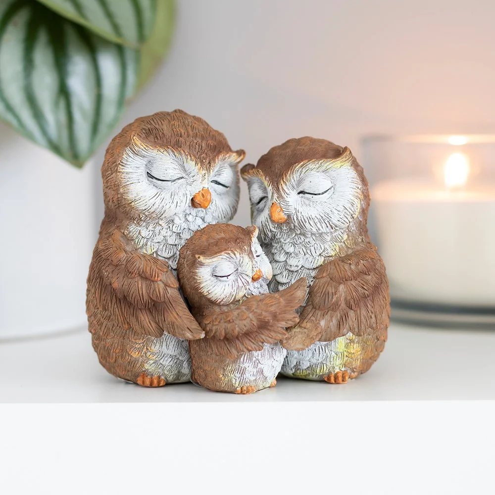 Resin owl family ornament showing three owls embracing, with gift box and sentiment card included