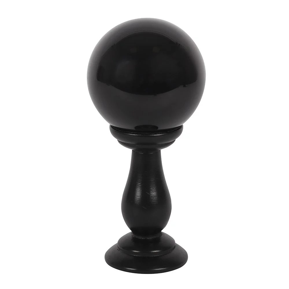 Small black crystal ball on a black wooden stand, suitable for divination or Halloween decor.