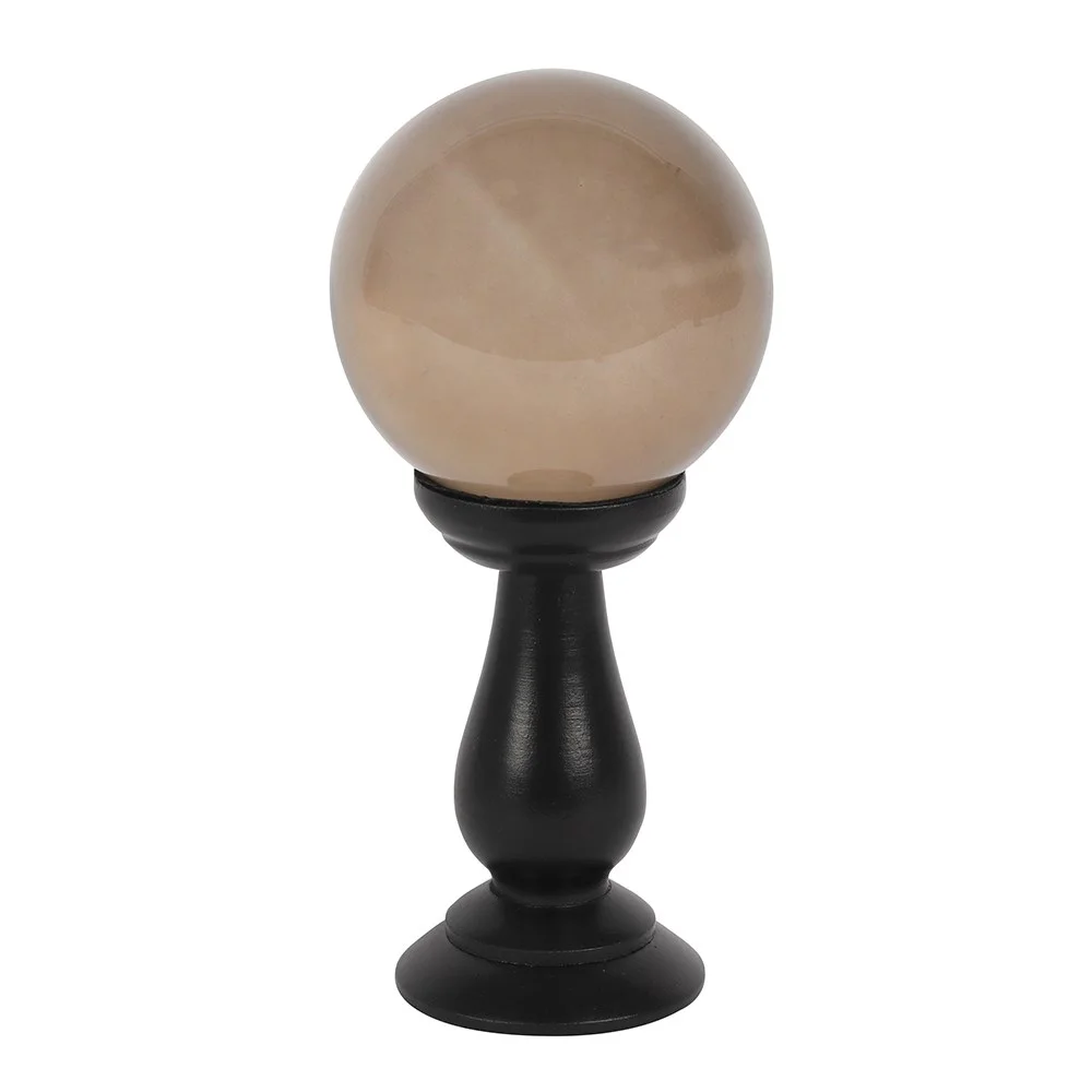 Smoky grey crystal ball on black wooden stand, a stylish crystal ball decor piece
