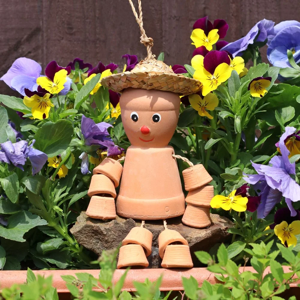 Small terracotta pot man wearing straw hat, designed to sit or hang in garden, 25cm tall with loop on hat