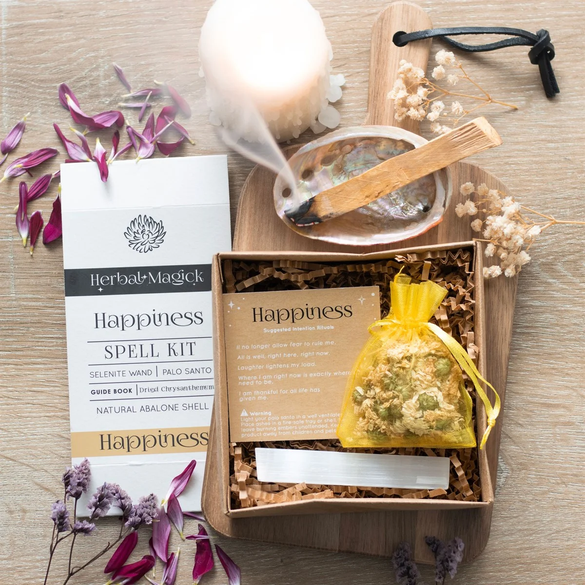 Happiness spell kit with selenite wand, dried sunflowers, abalone shell, Palo Santo sticks, guide book, and recyclable gift box