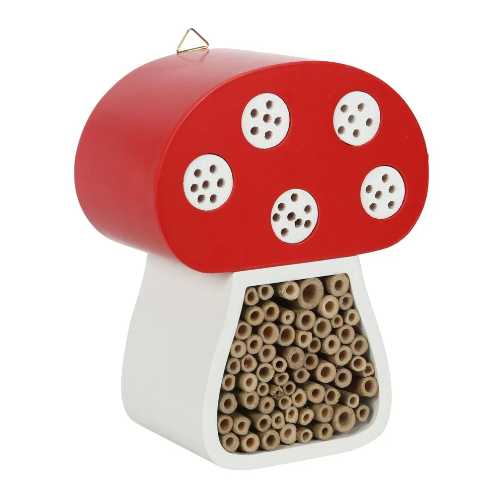 Colourful mushroom insect house shaped like a toadstool, designed to attract bugs and insects in the garden.
