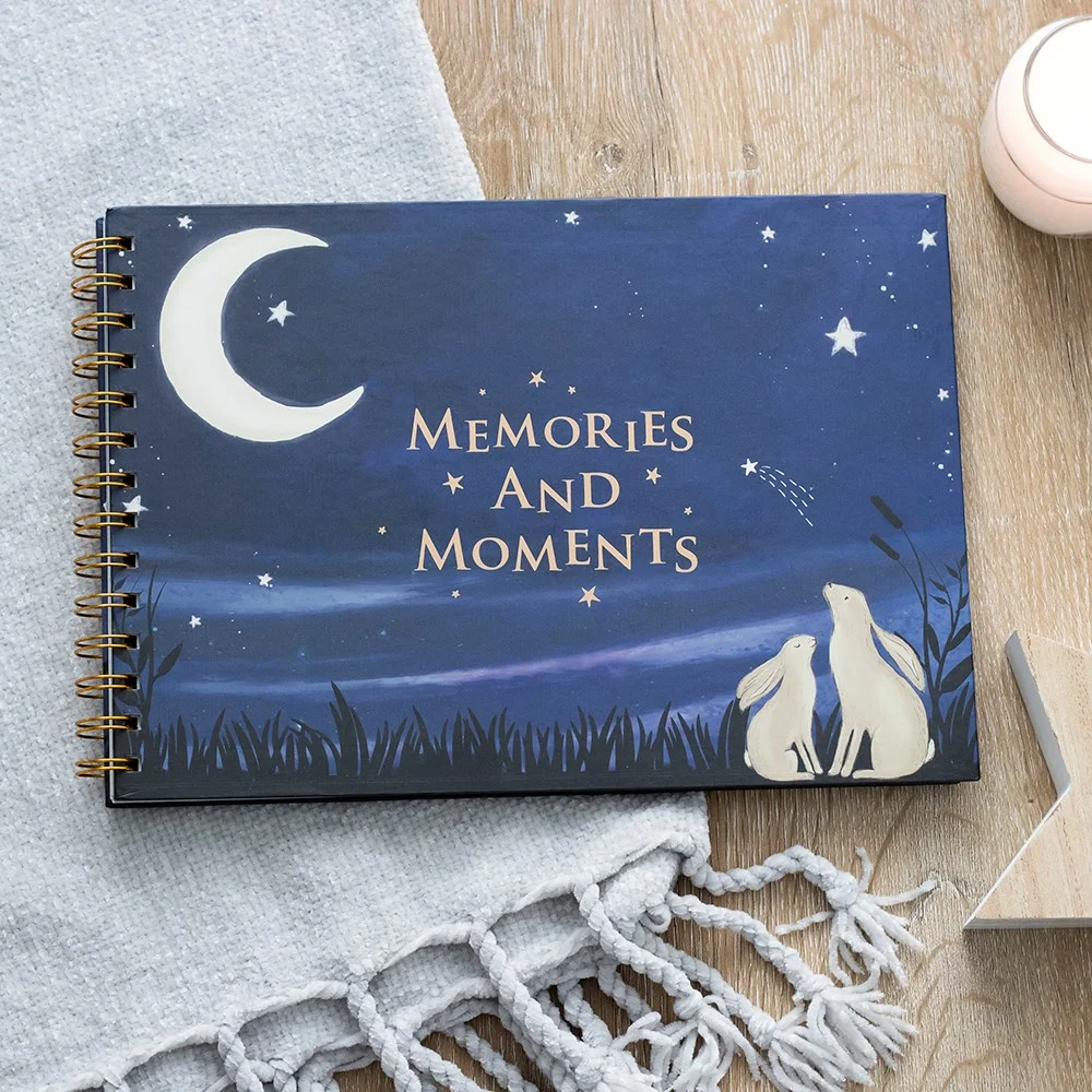 Blue baby memory book titled Look At The Stars with gold stars and moon illustrations on the cover