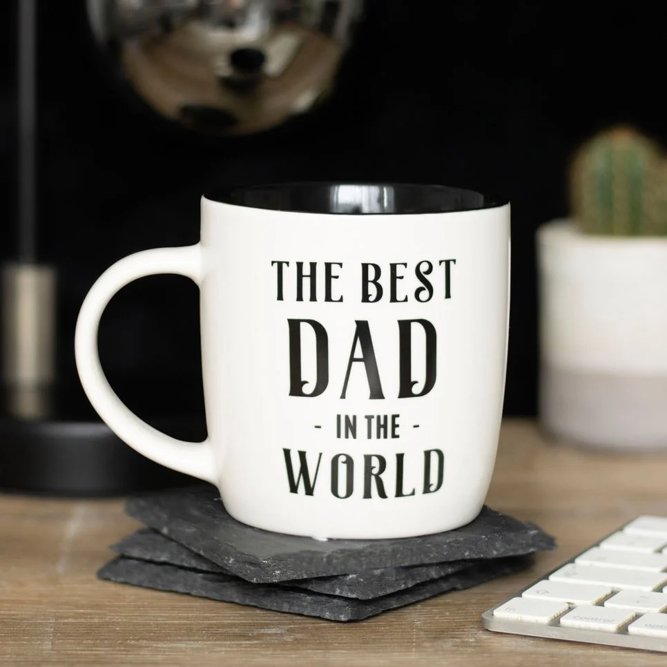 White ceramic Best Dad mug with black text saying "Best Dad in the World" on a plain background