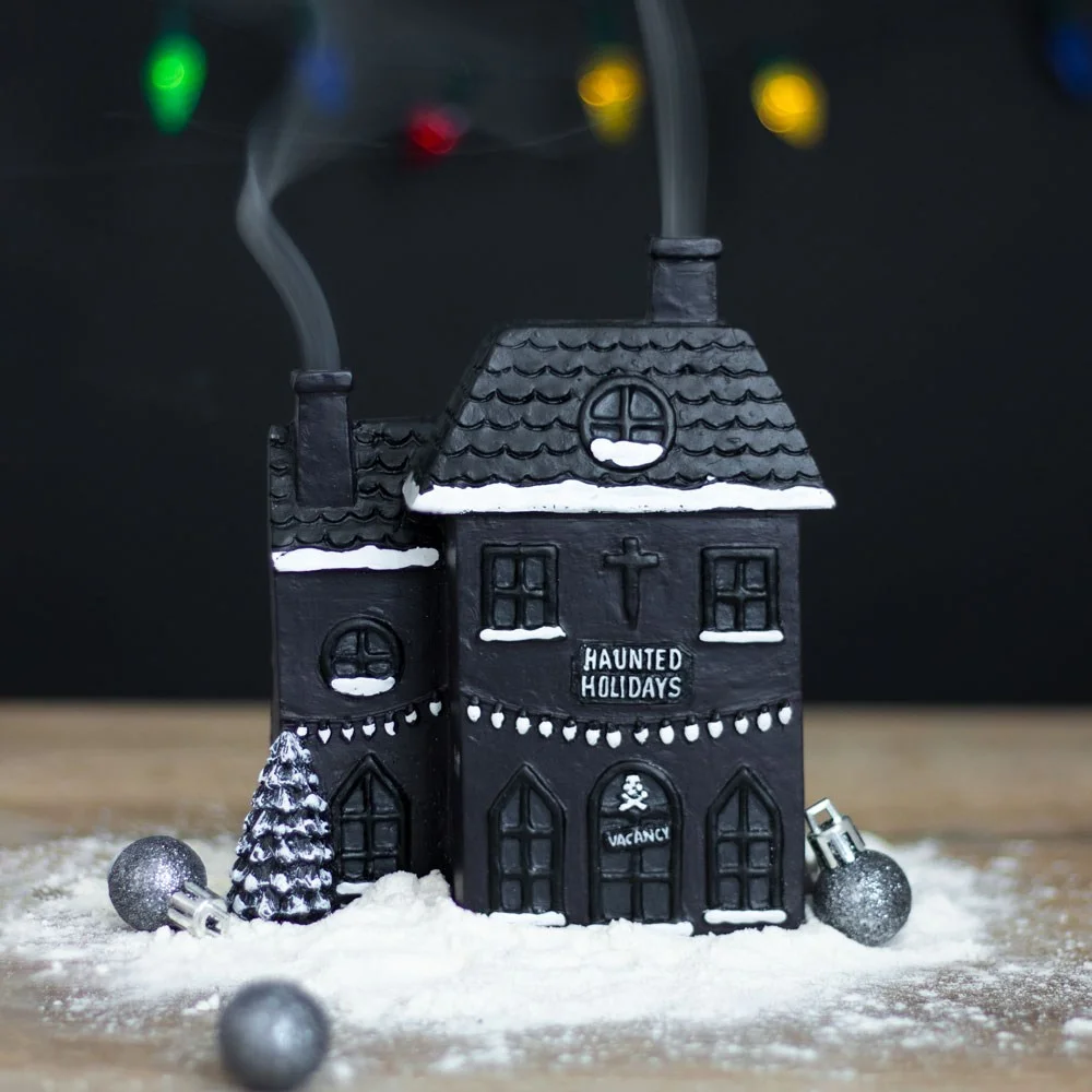 Black haunted house incense burner with two chimneys emitting smoke, gothic holiday home décor, 14cm tall.