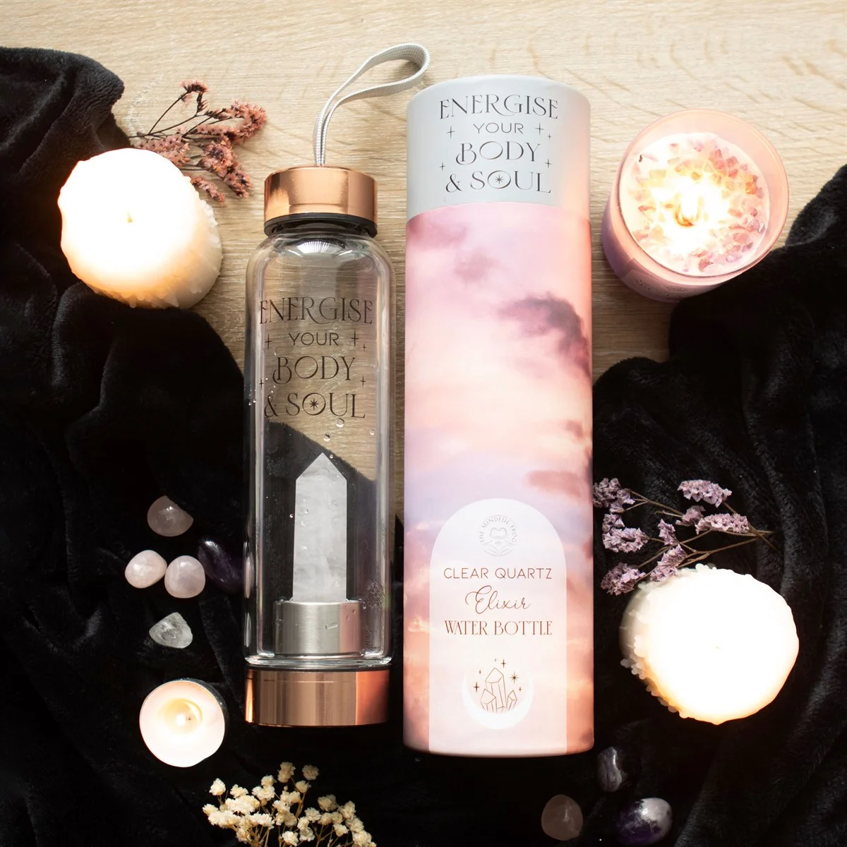 Clear quartz water bottle with glass body, natural crystal point base, stainless steel lid, and Energise your body & soul text