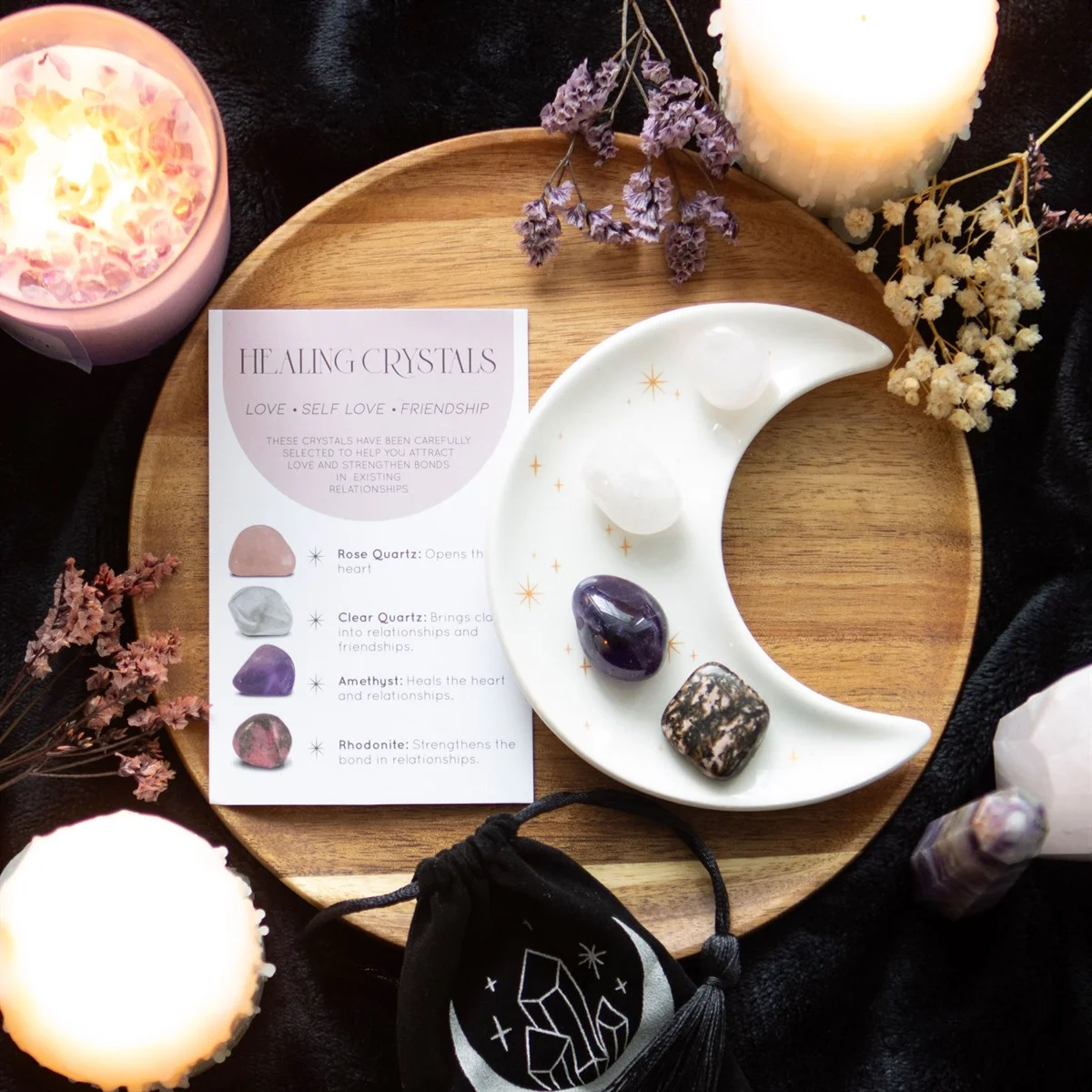 Healing crystal set with rose quartz, clear quartz, amethyst, rhodonite stones and crescent moon trinket dish on white background