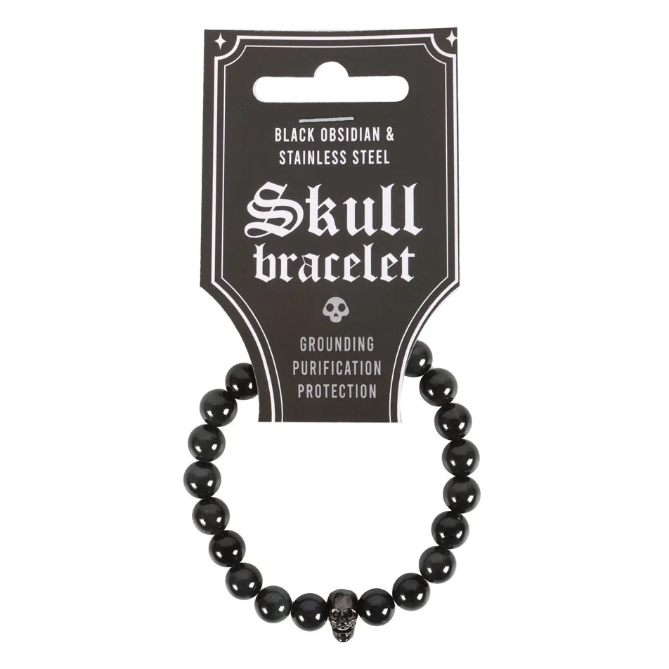 Black obsidian bracelet with round beads and a black stainless steel skull charm on an elasticated band