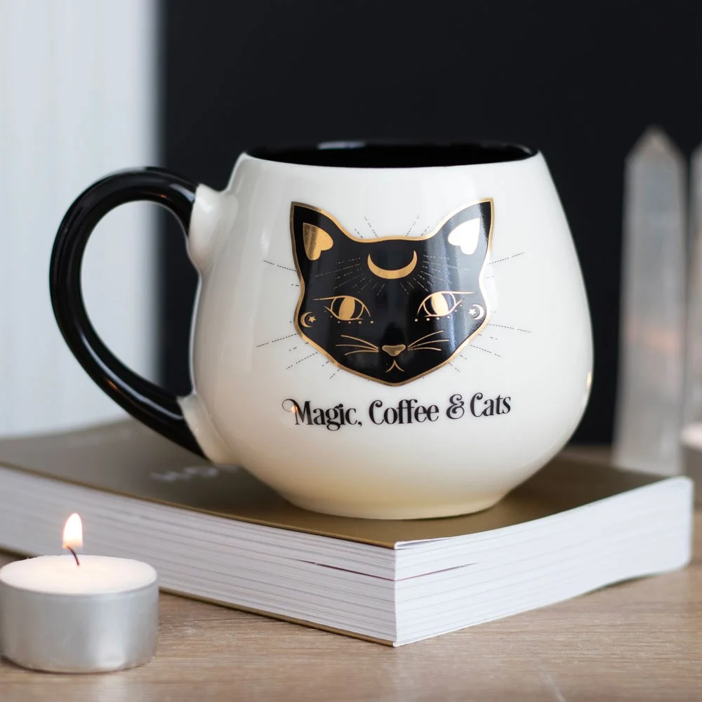 White rounded mug with black cat and gold accents, text "Magic, Coffee & Cats," 500ml magical cat mug design