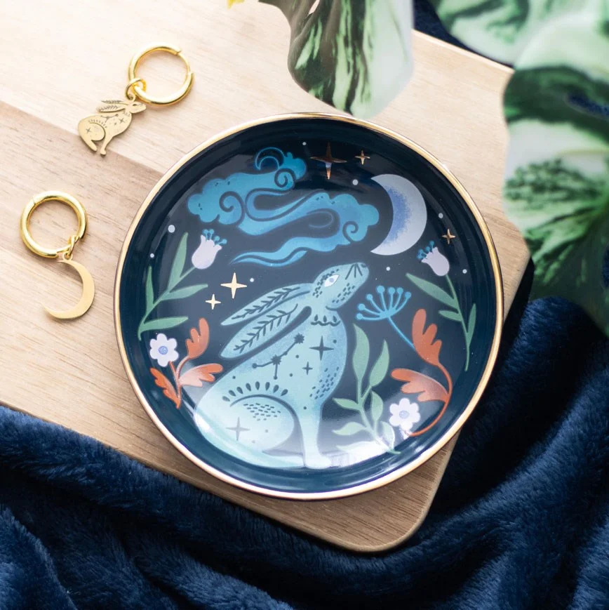 Midnight hare trinket dish with a moon gazing hare under a starry night sky and golden details on ceramic dish