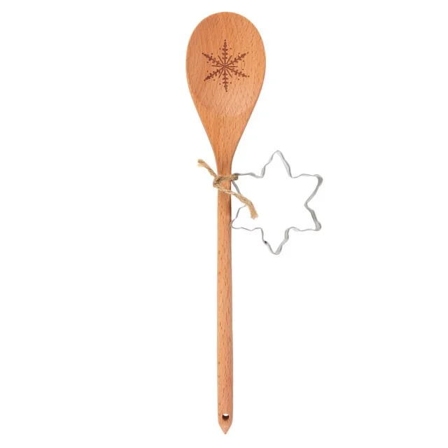 Christmas baking set with a wooden spoon and snowflake cookie cutter on a white background