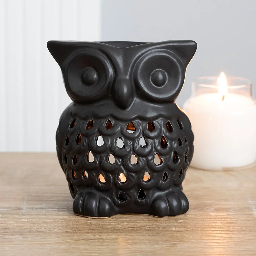 Black owl oil burner with cut out details showing candlelight inside, 12cm tall, for wax melts or oil use