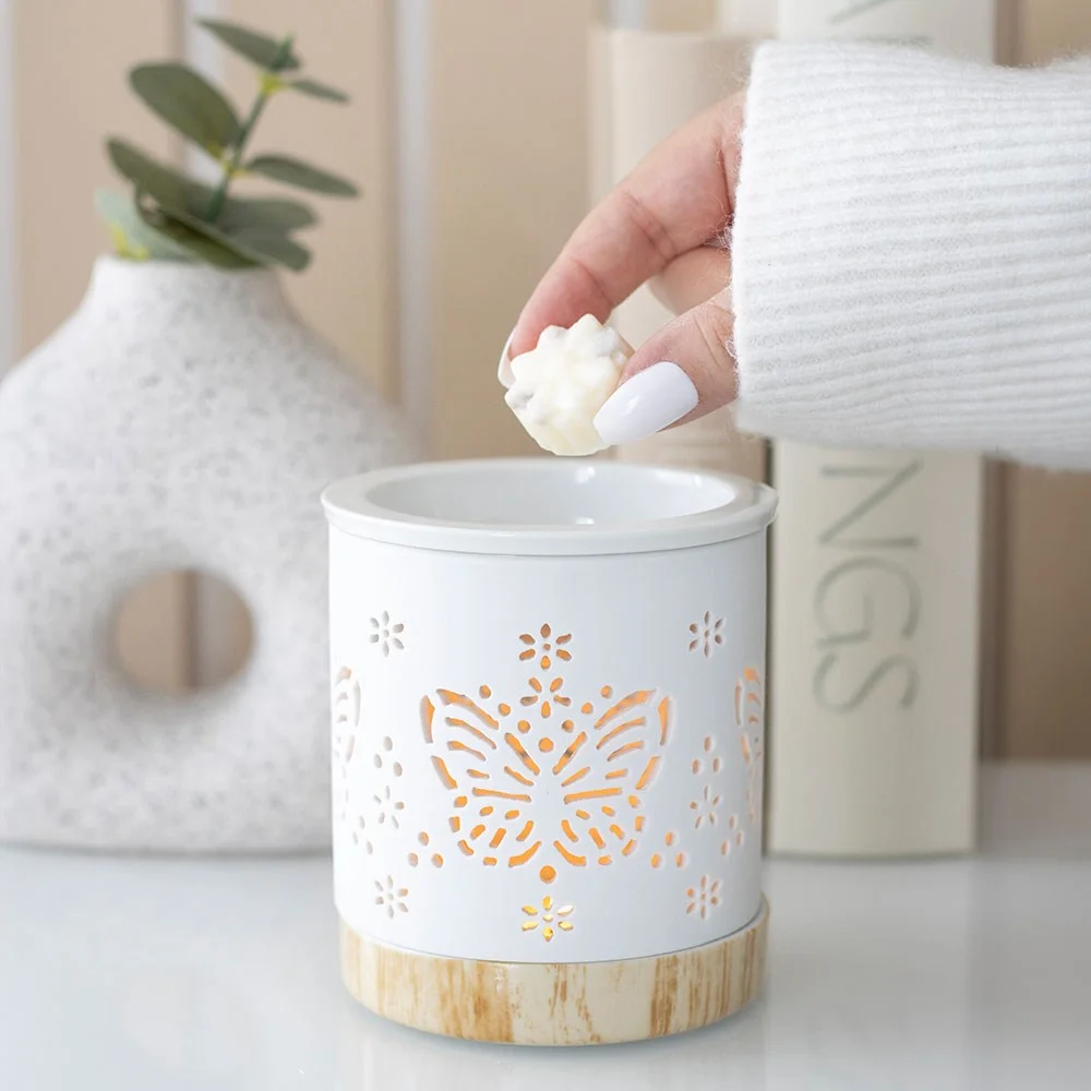 White matte ceramic butterfly oil burner with cut‑out butterfly detail, ready for a tealight.