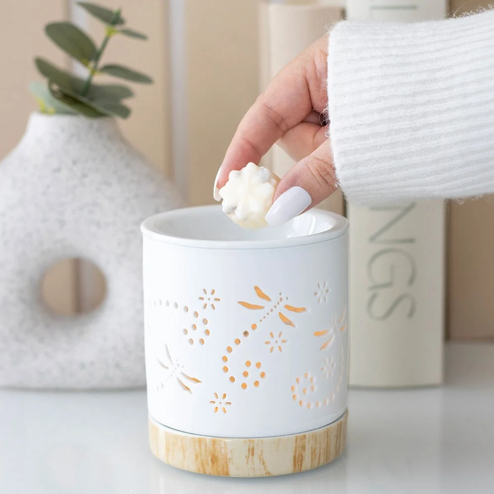 Matte ceramic dragonfly oil burner with dragonfly detail and wood‑effect base, contemporary design.