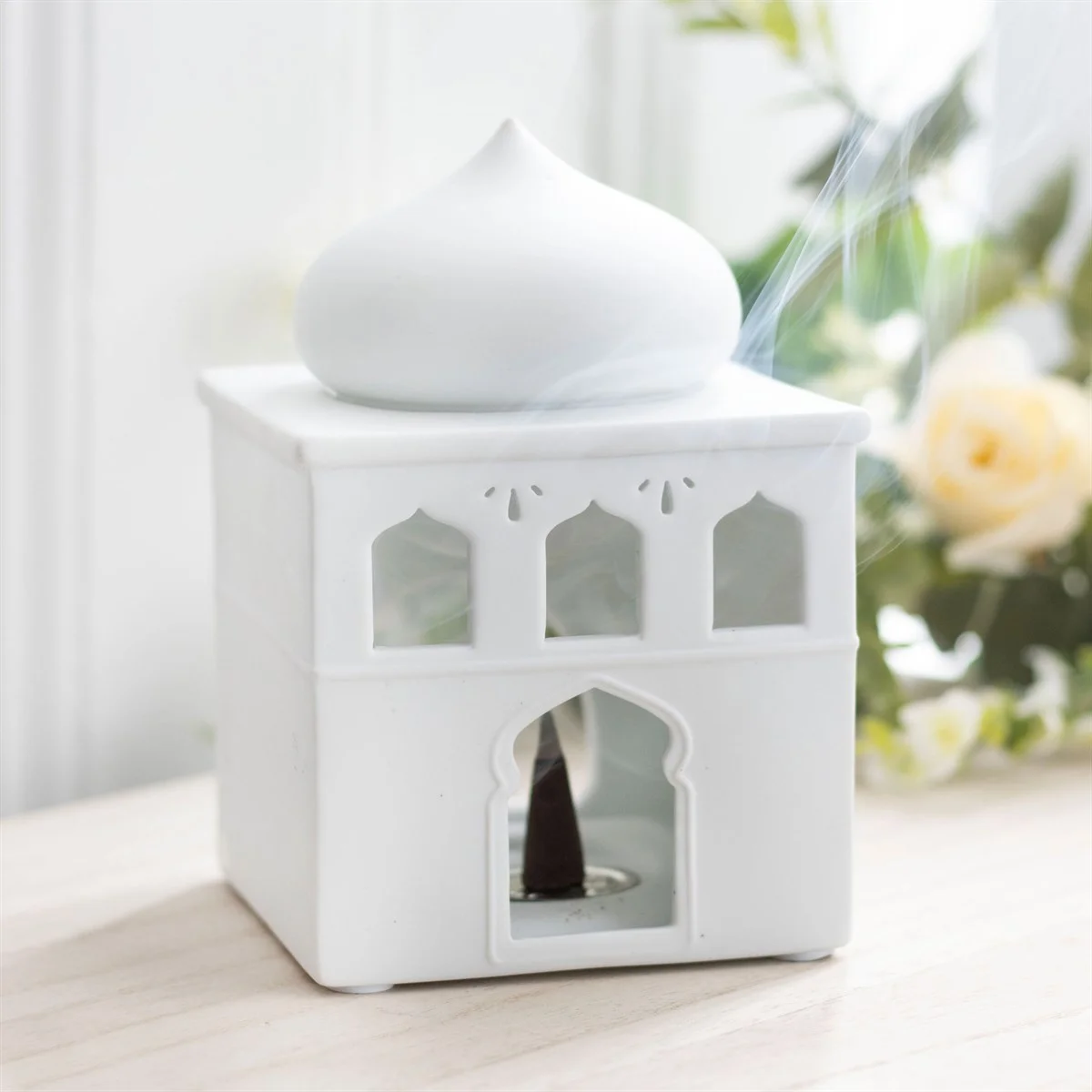 Glossy off-white mosque oil burner with lit windows and door, designed for fragrance oil and incense cones
