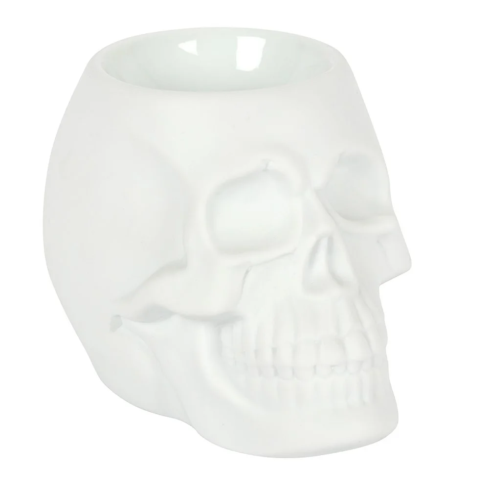 White skull oil burner made of matte ceramic, featuring a deep bowl for fragrance oils or wax melts
