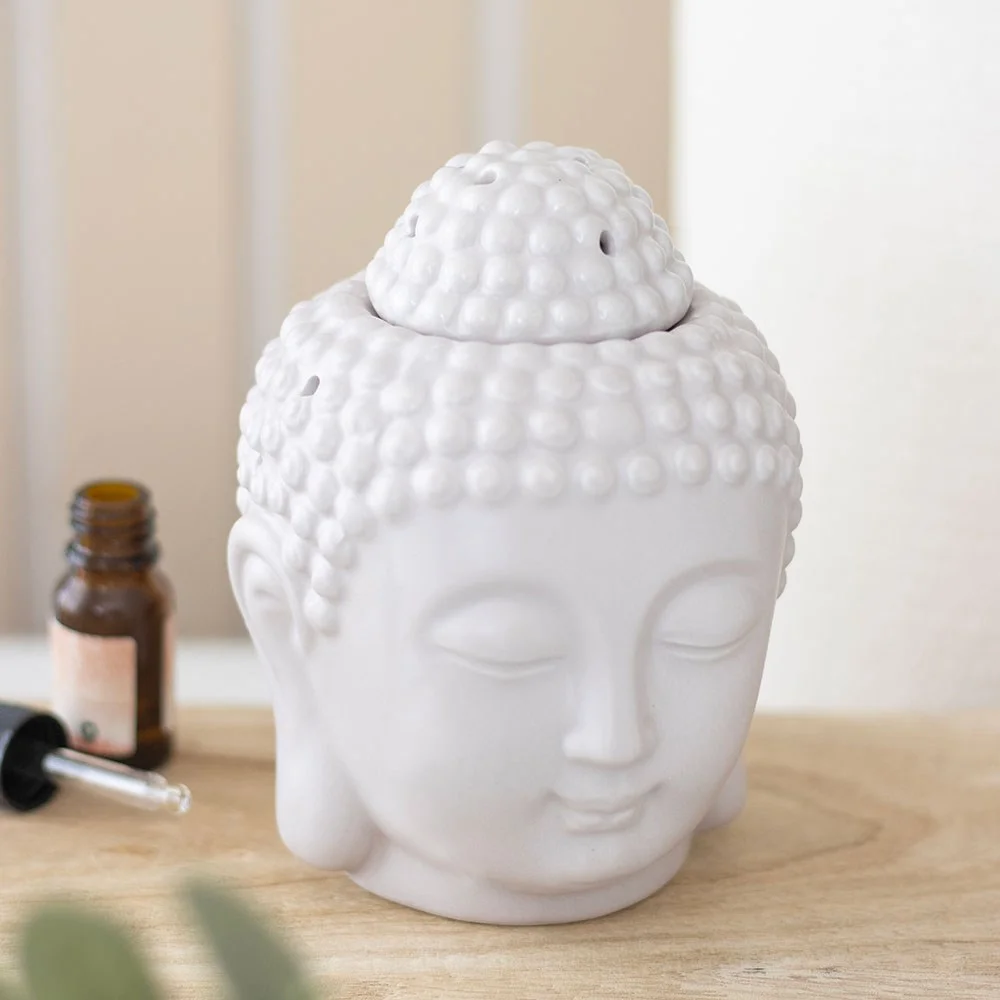 Small grey ceramic Buddha head oil burner with smooth finish, designed for fragrance oils and wax melts, 13cm tall