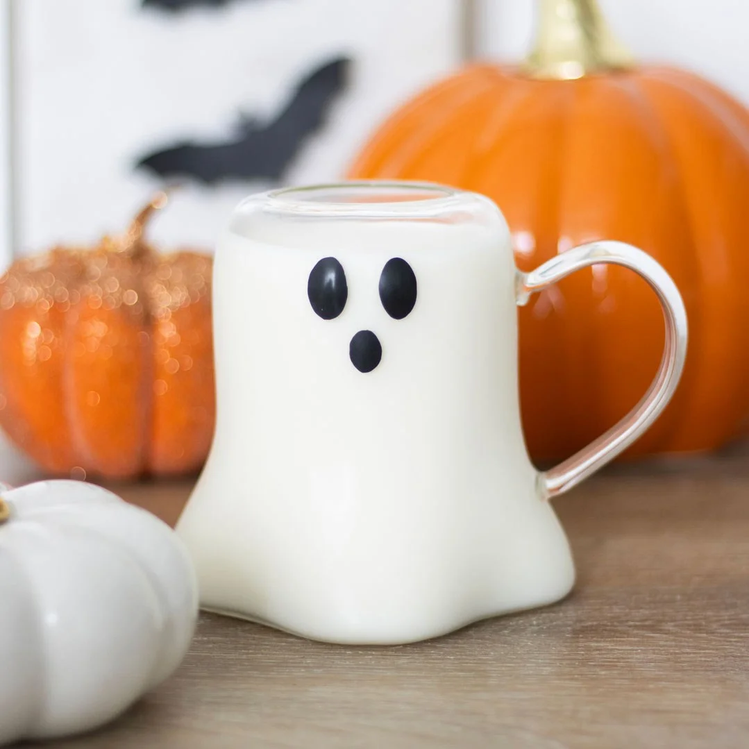 Clear ghost shaped glass mug holding a warm drink, showing the ghost silhouette inside, 600ml capacity.