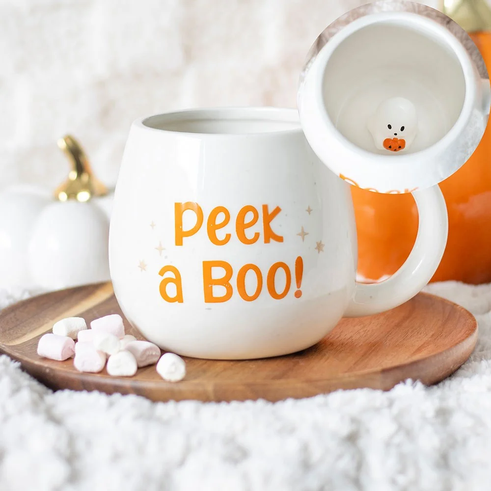 White Halloween ghost mug with rounded shape, "Peekaboo" text, and hidden ghost inside, 500ml capacity, hand wash only