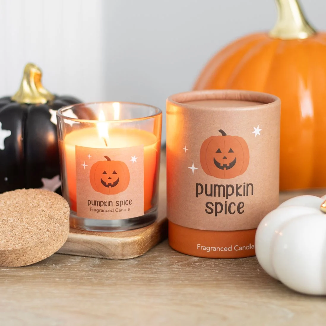 Smiling Jack-o'-lantern pumpkin spice candle with cork lid, vegan wax, perfect for Halloween decor and autumn scents