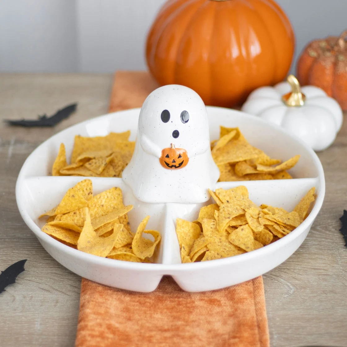 White ceramic ghost chip and dip dish with a ghost-shaped dip cover and surrounding sections for snacks