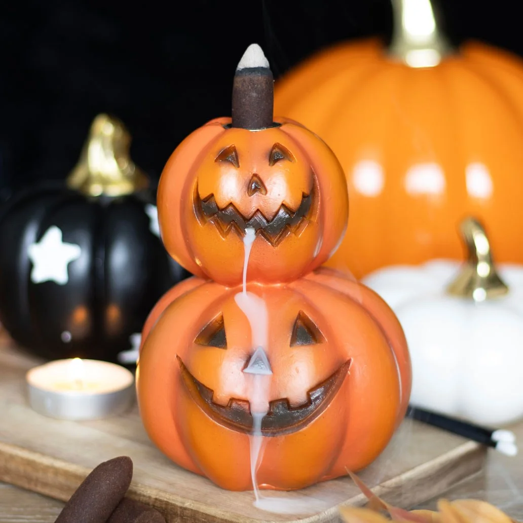 Stacked pumpkins backflow incense burner with smoke flowing down through carved pumpkin mouths on a Halloween theme
