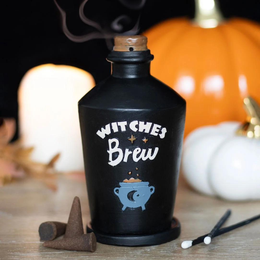 Glass potion bottle incense burner with cork top, designed as a witches brew, emitting smoke from the cork.