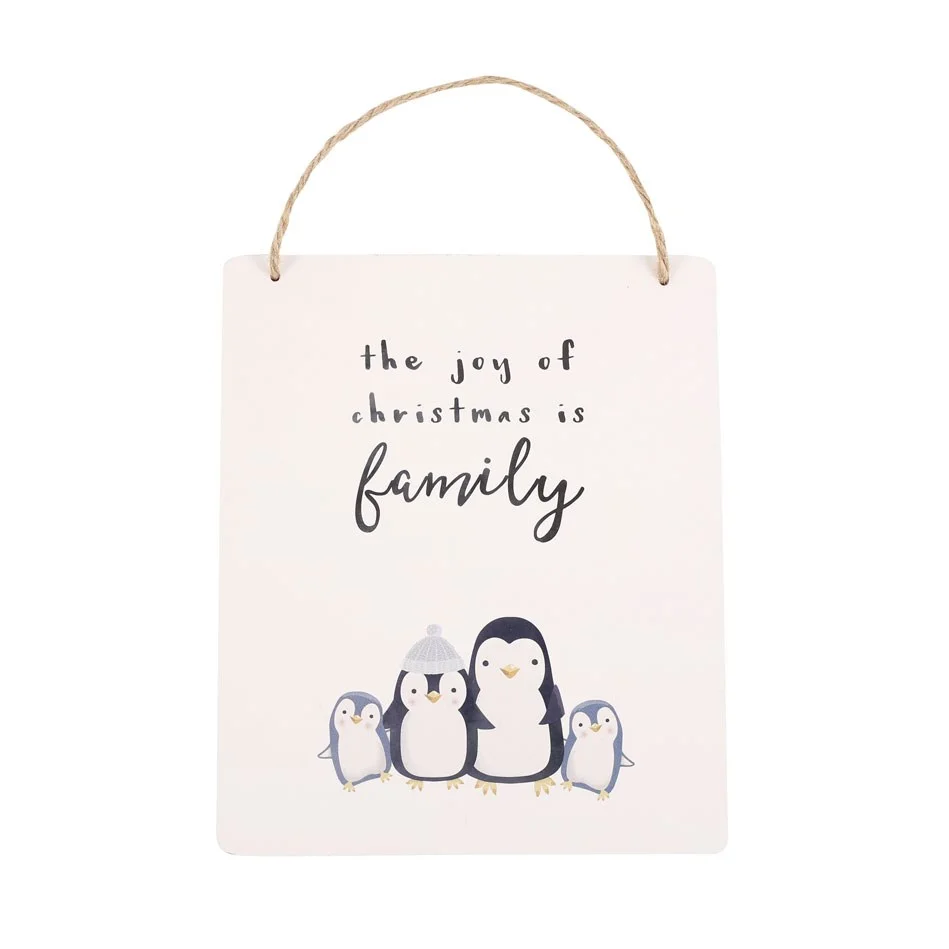 Christmas hanging sign featuring a family of chubby penguins with the text "The joy of Christmas is family