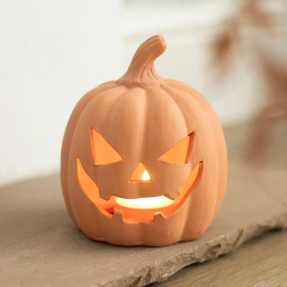 Terracotta pumpkin ornament 12.5cm with carved jack-o-lantern face and tealight holder for Halloween decor