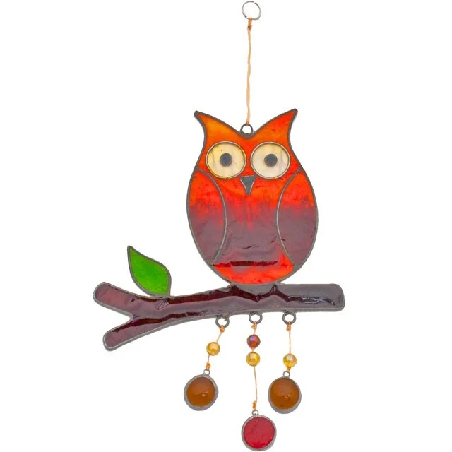 An owl suncatcher hanging from a branch, glass translucent, dimensions 15.5cm high by 13.5cm wide.