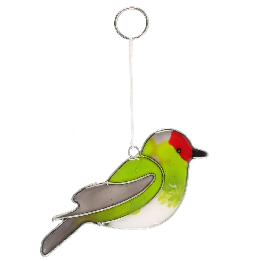 goldfinch bird suncatcher hanging inside a window, reflecting light