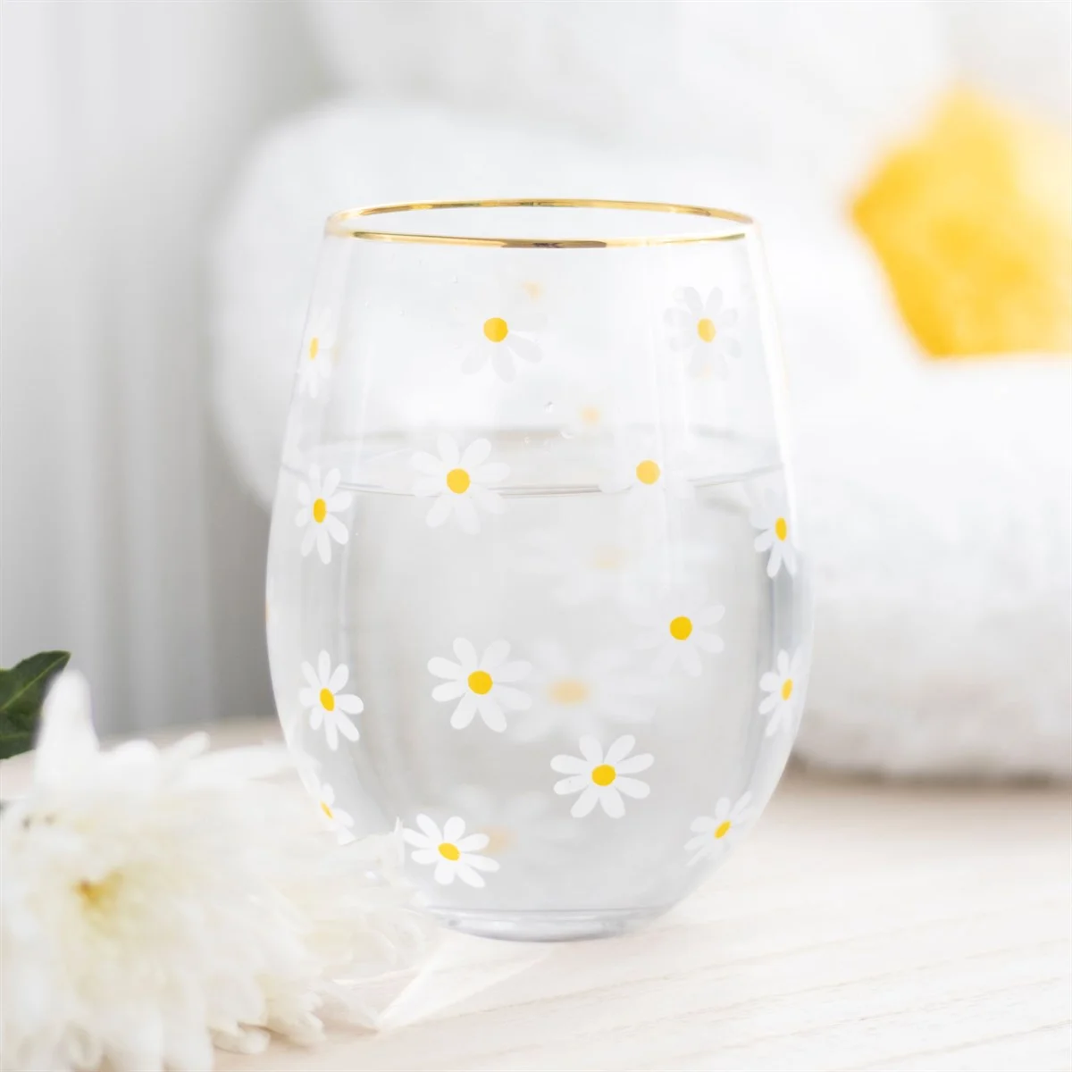 Stemless wine glass with all-over daisy print and gold-tone rim, 500ml capacity, on a white background