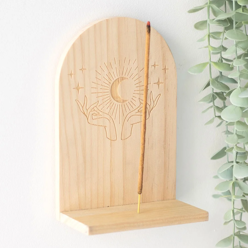 Wooden incense holder shelf with mystical hands design, mounted on wall displaying crystals and incense sticks