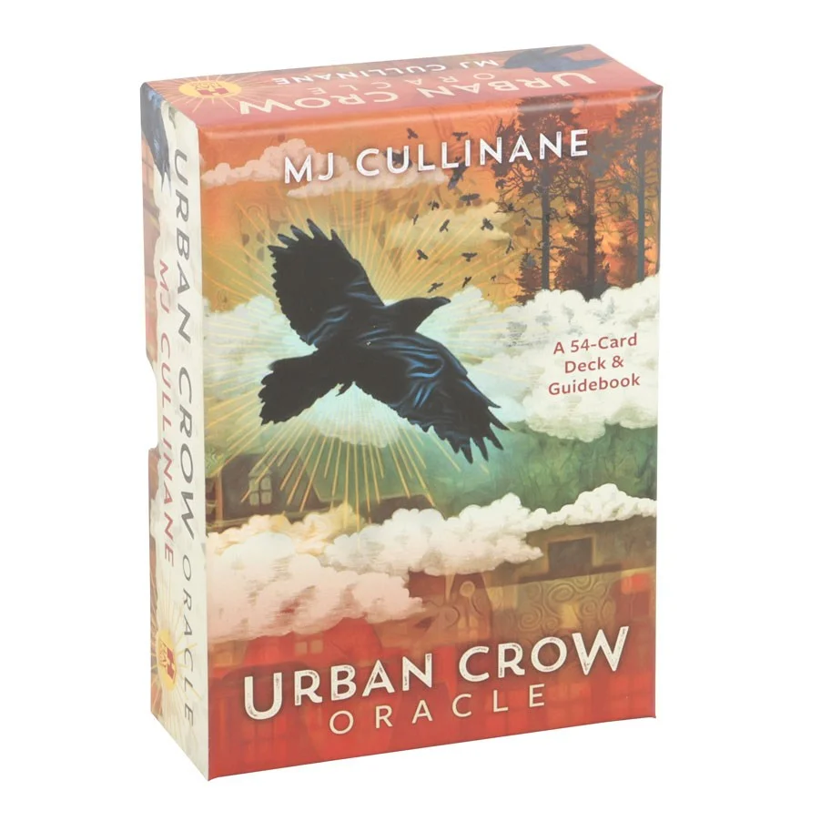 Urban Crow Oracle Cards deck spread with crow-themed illustrations and guidebook on a wooden surface