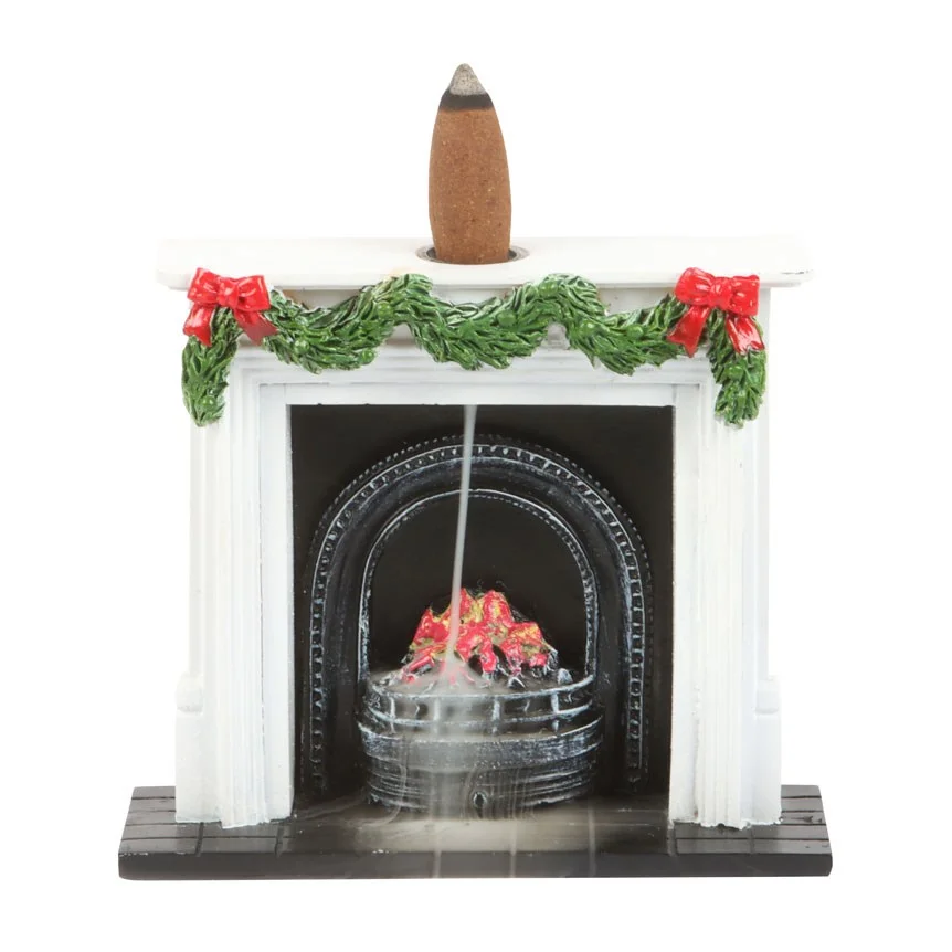Christmas incense burner shaped like a festive fireplace with garland and smoke flowing over red coals
