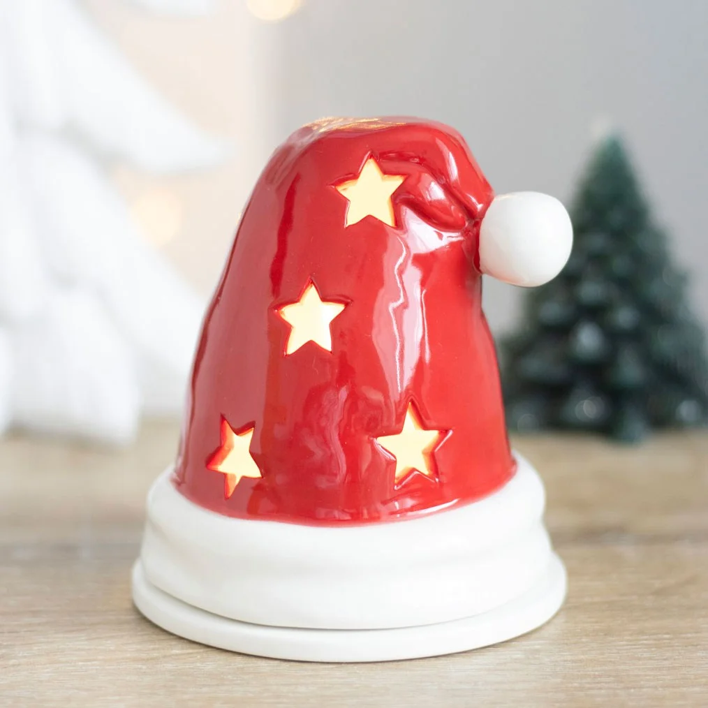 Red Santa hat incense burner with star cutouts, designed as a tealight holder and incense cone burner for Christmas decor