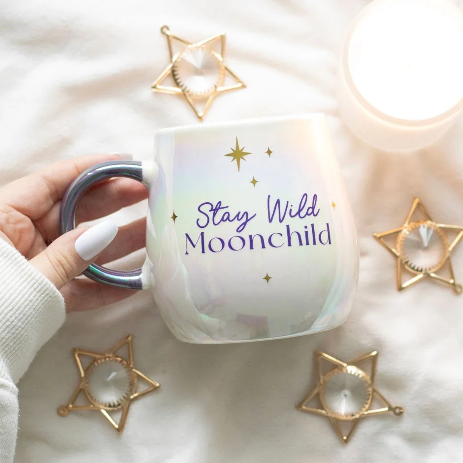 Stay Wild Moon Child mug with opalescent finish, gold lettering, purple handle, and rounded shape holding 500ml liquid
