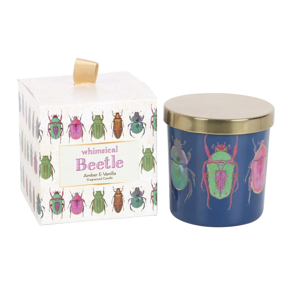 Blue beetle candle in blue glass holder with colorful beetle design and gold lid on white background