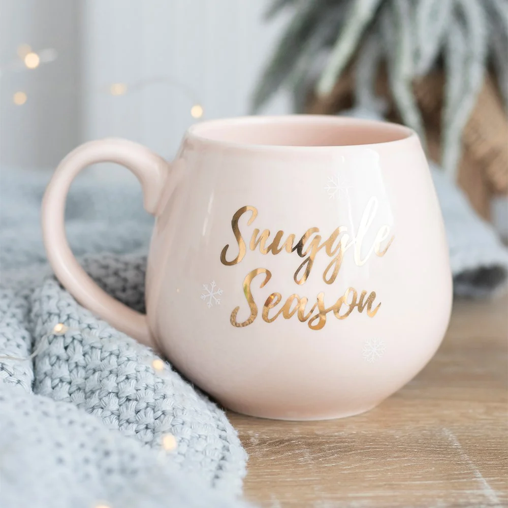 Pink ceramic snuggle season mug with rose gold detailing, 9.5cm tall, ideal for cold winter days.