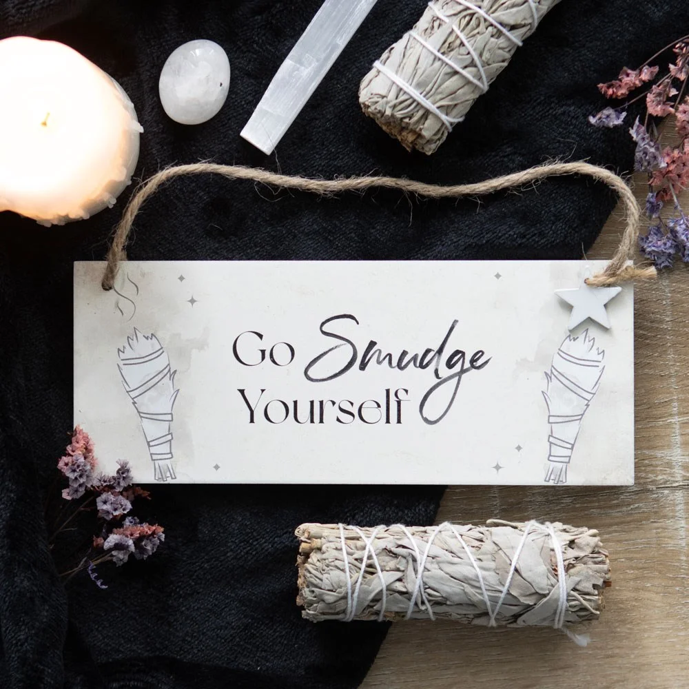Funny hanging sign with "Go smudge yourself" text and smudge sticks illustration on wooden board with rope hanger