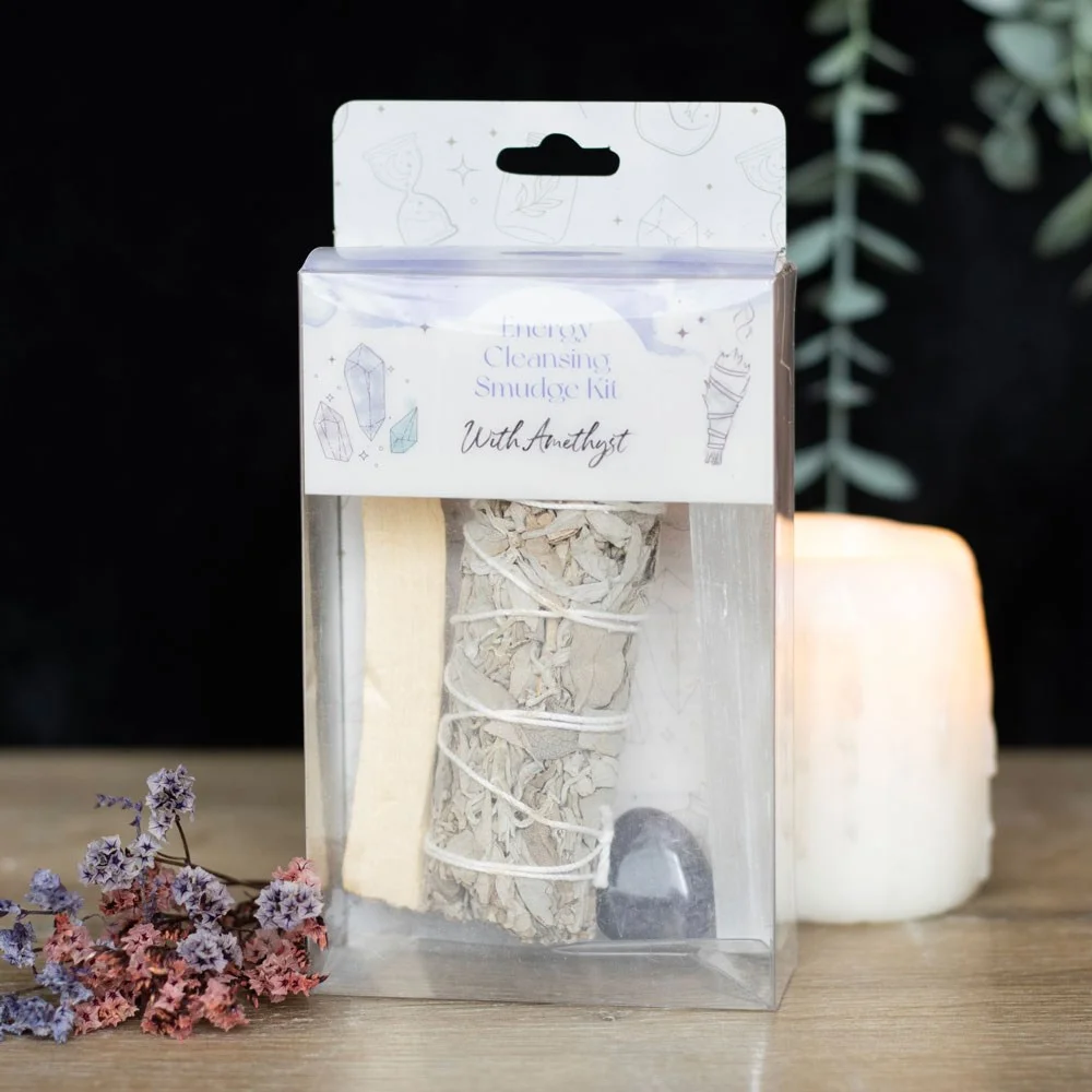 Smudge kit with amethyst featuring white sage bundle, palo santo stick, selenite wand, and amethyst tumblestone on white background