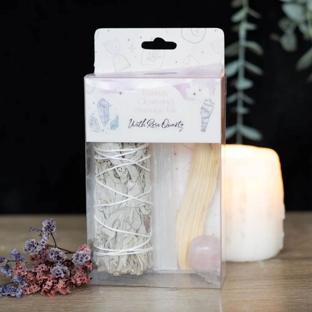 Smudge kit with rose quartz showing white sage bundle, palo santo stick, selenite wand, and rose quartz tumblestone crystal
