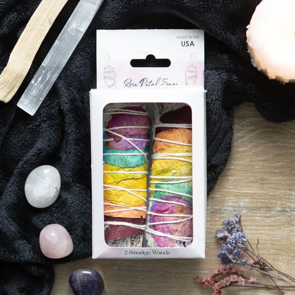 Two rose petal sage smudge wands made of dried white sage and colorful rose petals, used for spiritual cleansing rituals