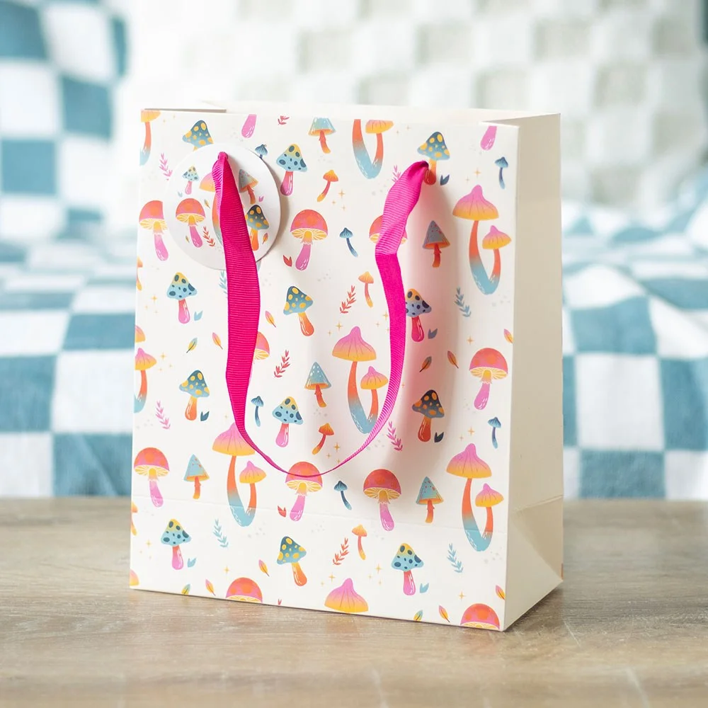 Colourful 23cm tall mushroom print gift bag with 60s funky fungi design for gifting occasions