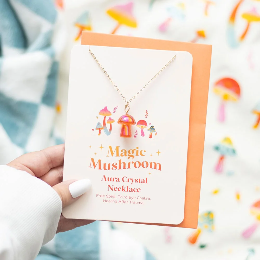 Bright orange mushroom necklace displayed on a greeting card with matching envelope, symbolising healing and free spirit