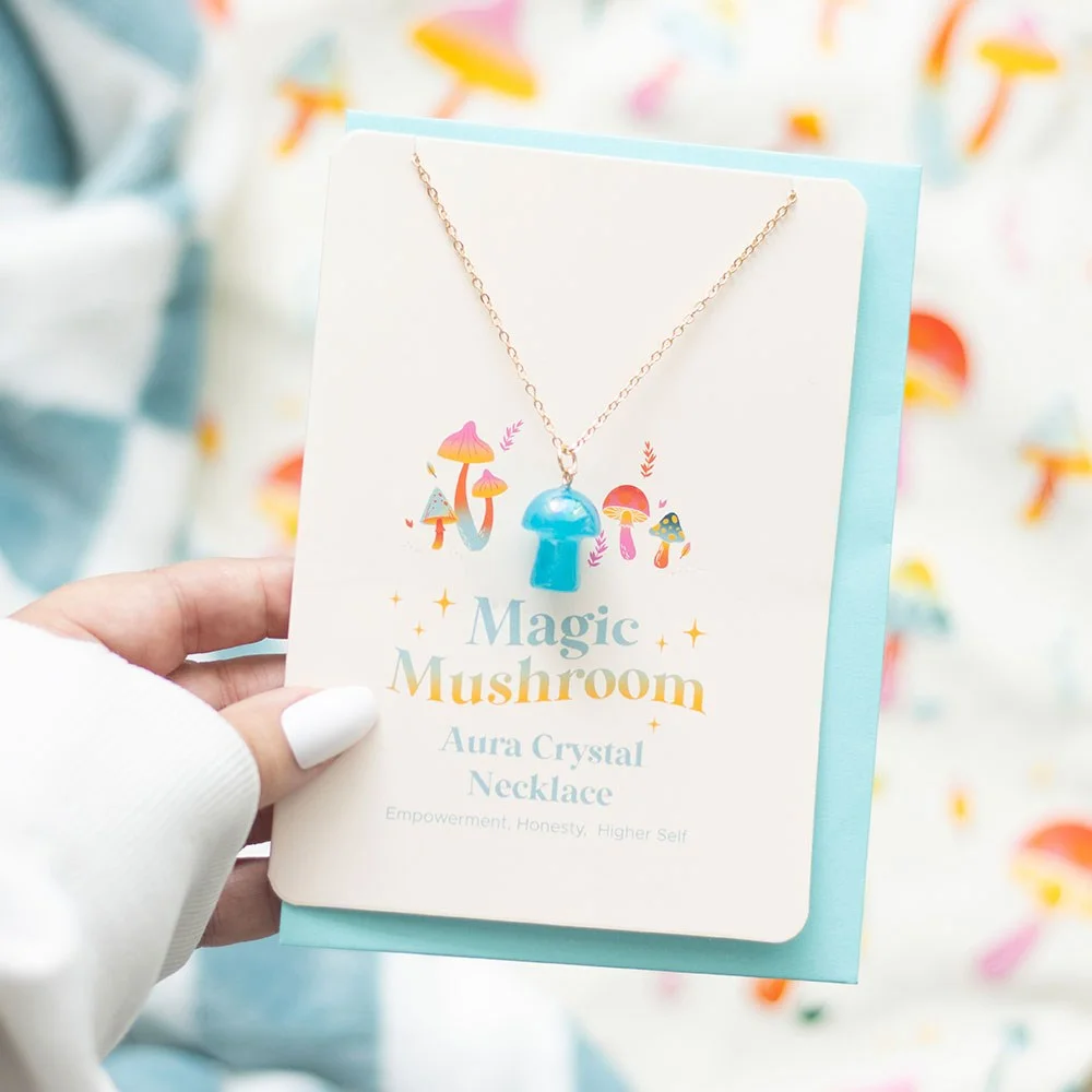 Blue mushroom necklace with bright aura design on a greeting card, includes matching envelope and blank interior.